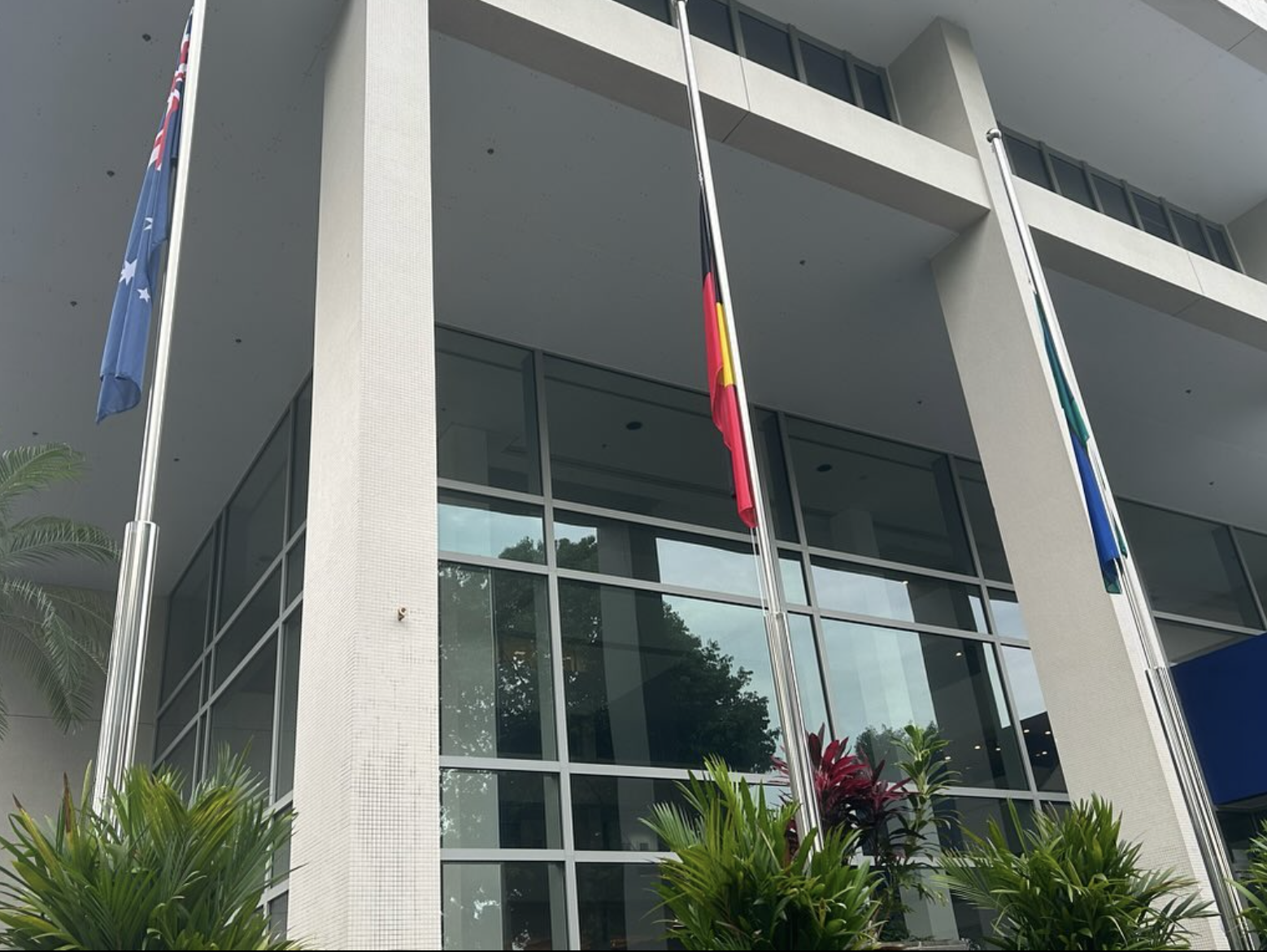 The three flags at half-mast at the Australian High Commission in Singapore.